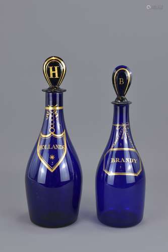 Two Blue glass liquor bottles with stoppers – Holl