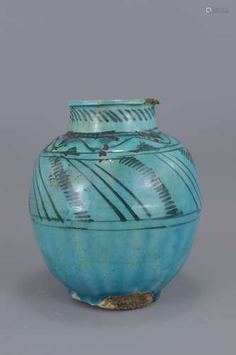 An Islamic Medieval turquoise glazed vase. 22cm he