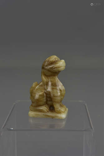 A Chinese carved celadon jade figure of a seated d