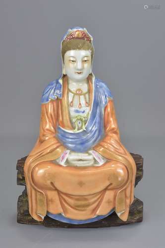 A Chinese 20th century porcelain Guanyin figure seated on separate carved wooden stand. Total 30cm t