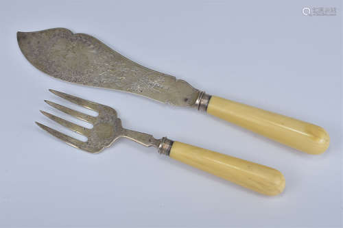 A set of silver and ivory handled fish servers.