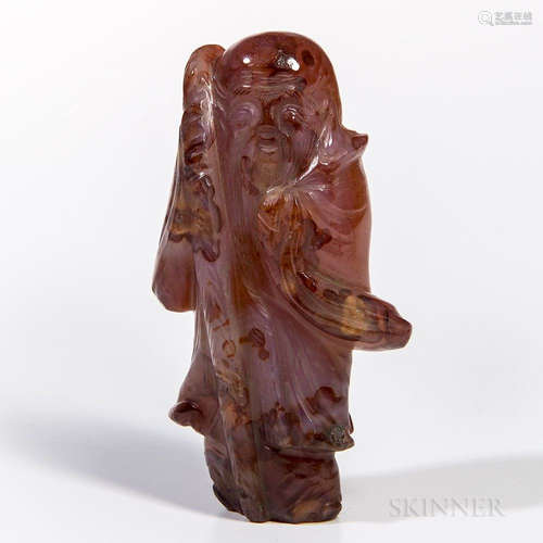 Agate Carving of Shoulao, China, standing with a staff in his right hand, mottled red stone with gray streaks and spotty black inclusio