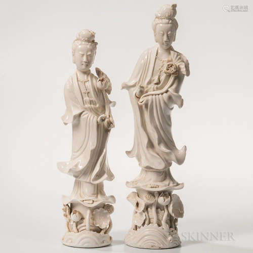 Two Blanc-de-Chine Figures of Guanyin, China, 20th century, both standing on a lotus base with a lotus stalk in her left hand, each wit