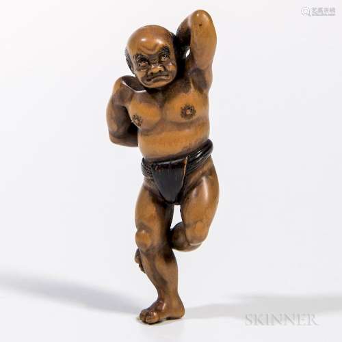 Carved Boxwood Netsuke, Japan, Edo period, in the shape of a sumo wrestler performing a warm-up exercise, lacquered details, signed 