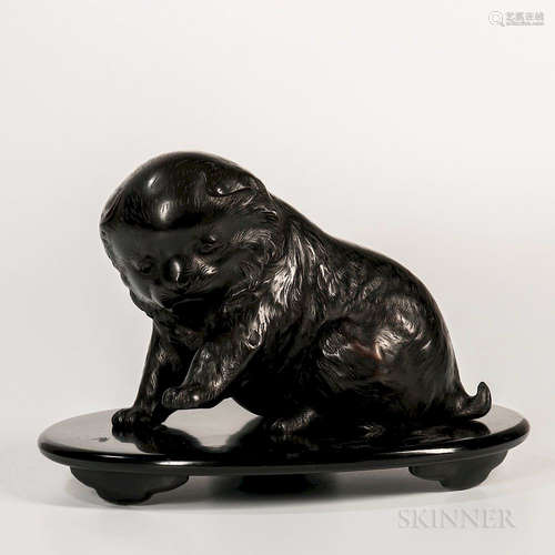 Bronze Puppy, Japan, Meiji period, seated with its left foreleg slightly raised, signed 