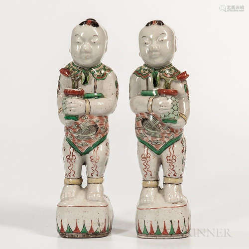 Pair of Famille Verte Figures of Boys, China, 18th century, both depicted holding a vase of lotus flowers, wearing ruyi-head collars, c