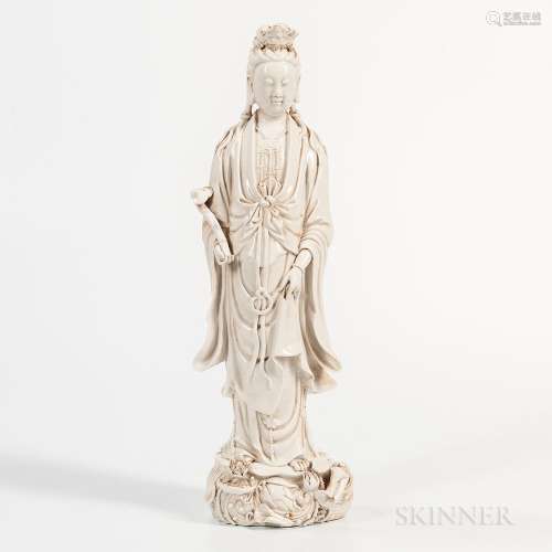 Blanc-de-Chine Figure of Guanyin, China, 20th century, standing on lotus-and-wave base, with a ruyi scepter in her right hand, mark to