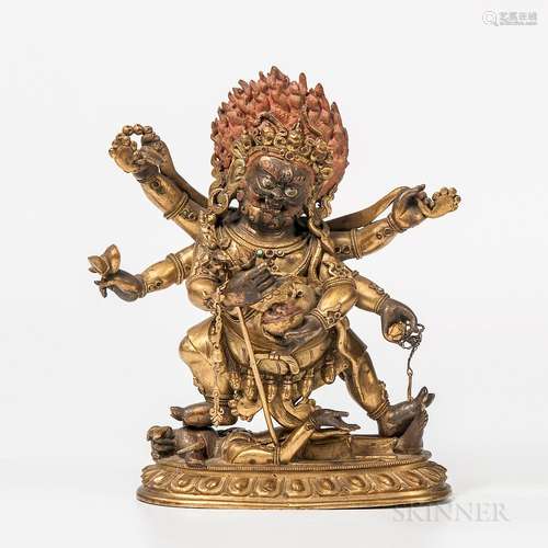 Gilt-bronze Figure of the Six-armed Mahakala, Sino-Tibet, 18th century, standing on a prone elephant-headed deity on an oval lotus base