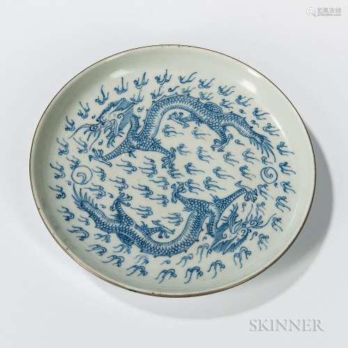 Blue and White Dish, China, 18th/19th century, circular form with white brass rim, decorated with two dragons amongst clouds, 