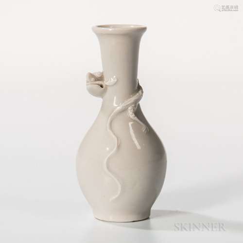 Small White-glazed Bottle Vase, China, 19th century, decorated with a carved chilong to neck, the glaze with gray tint, ht. 4 1/2 in. P