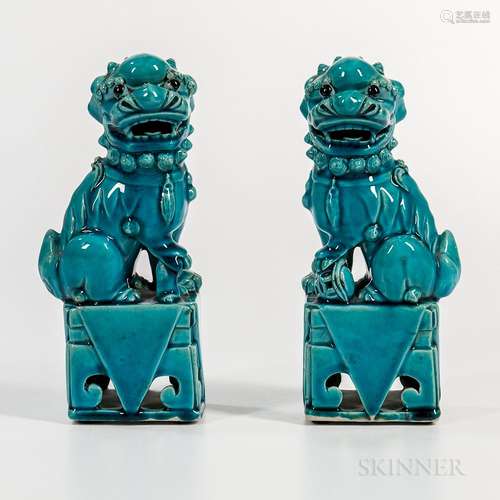 Pair of Turquoise-glazed Foo Dogs, China, each seated on its hind legs on an openwork podium, black-glazed eyes, ht. 8 in.