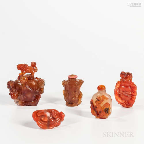 Five Agate Snuff Bottles, China, 19th/20th century, in various shades of red and russet, a master snuff carved with shishi, a smaller b