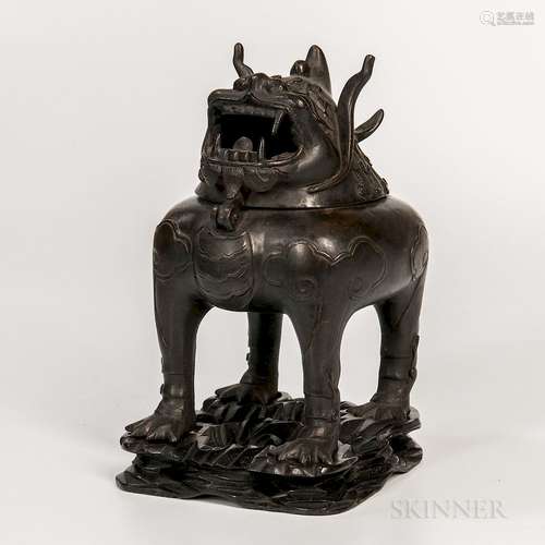 Bronze Qilin-shaped Censer, China, 19th/20th century, with hinged head as the cover, molded and line details, with a conforming wood st