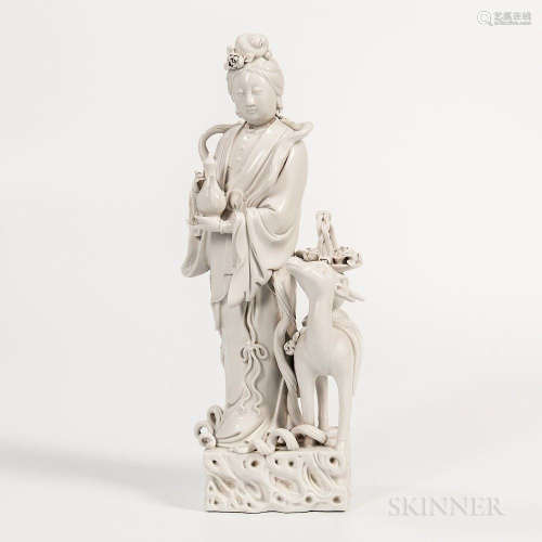 Dehua Figure of Guanyin, China, 19th/20th century, standing with deer on a square rockery, holding an ewer, 