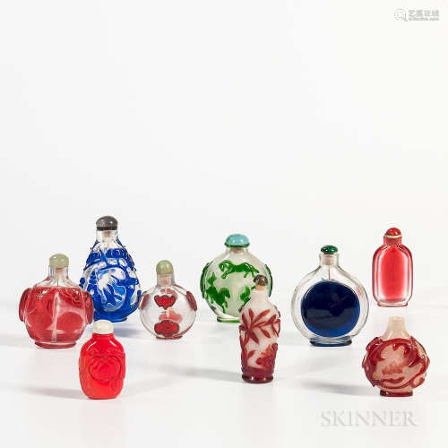 Nine Peking Glass Snuff Bottles, China, 19th/20th century, three milky glass with single-color overlaid motifs, three clear with single