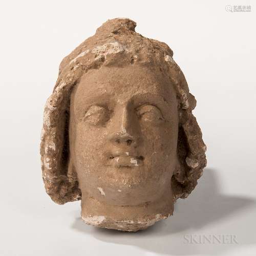 Gandharan Stucco Head, Kushan, possibly 4th/5th century, the head with heavily lidded eyes and full lips, with flowing hair held togeth