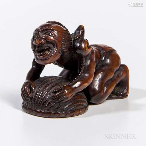 Carved Boxwood Netsuke, Japan, 19th century, in the shape of a prostrate man with a rat caught under a basket and another running over