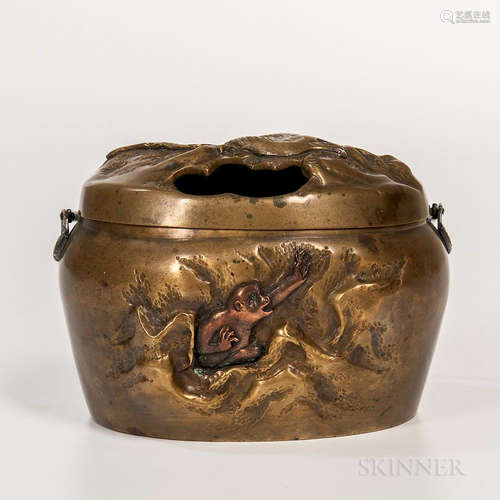 Yellow Brass Hand Warmer and Cover, Japan, Meiji period, decorated in relief with an eagle to the cover, an inlaid copper monkey in mou