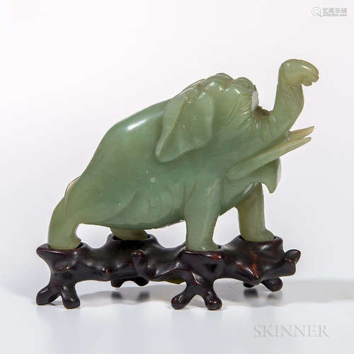 Hardstone Carving of an Elephant, Asia, 20th century, with its trunk up, with wood stand, jade green stone, ht. 4, wd. 6 5/8 in. Proven