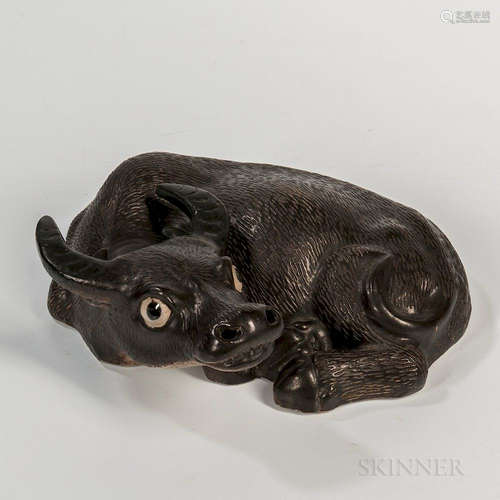 Black-glazed Ceramic Water Buffalo, China, reclining to one side with its head slightly upwards, incised details, bisque base, ht. 3 5/