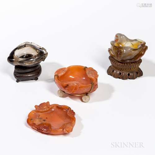 Four Carved Hardstone Brush Washers, China, one gray/russet agate, in the shape of a rolled lotus leaf; one smoky quartz, peach form; o