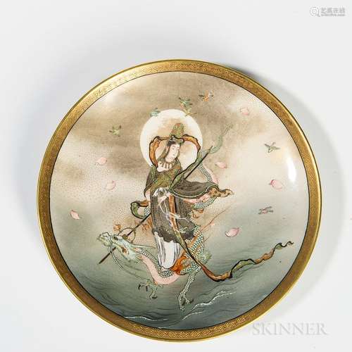 Kyoto Satsuma Plate, Japan, early 20th century, depicting Kannon riding on a dragon rising above water, a gilt patterned band around ri