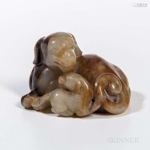 Jade Carving of a Dog and Puppy, China, the dog reclining with its head turned towards the puppy, celadon stone with russet to dark bro