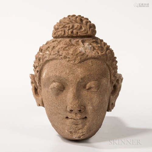 Gandharan Stucco Buddha Head, Kushan, possibly 4th/5th century, the finely carved head with heavily lidded eyes and arching brows, wavy