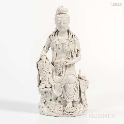 Dehua Figure of Guanyin, China, in the manner of He Chaozong, seated on a rock above water with her left foot on a lotus flower, double