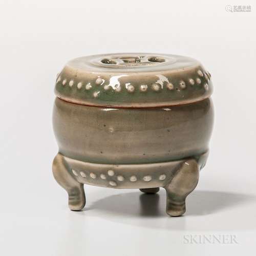 Small Celadon-glazed Drum-shape Box and Cover, China, Ming dynasty style, resting on three stylized animal head feet, decorated with tw