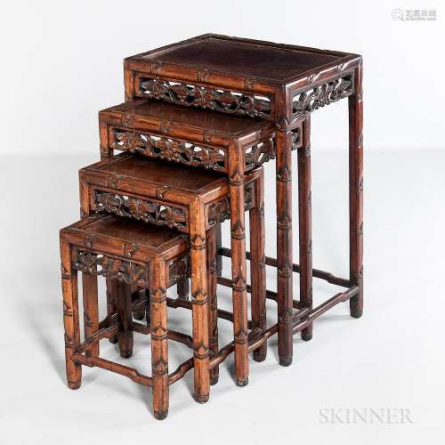 Four Carved Hardwood Nesting Tables, China, 20th century, top panels set in carved frames depicting bamboo, apron with openwork floral