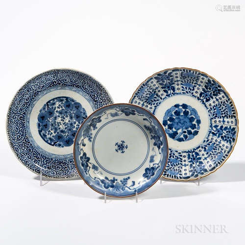 Three Export Blue and White Plates, Japan, 18th/19th century, a lobed dish with floral roundel and foliate scroll band; a barbed dish w