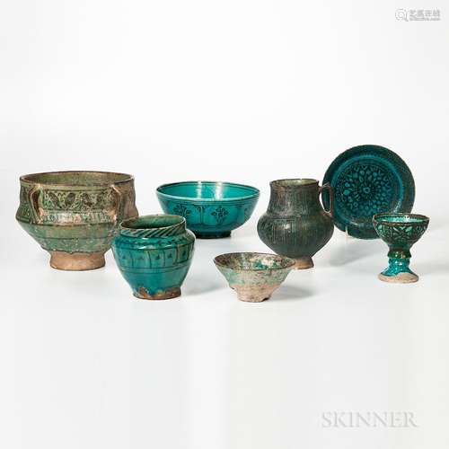 Seven Kashan Turquoise and Black Vessels, Persia, 18th to 20th century, a large deep handled bowl with foliate decoration, a pitcher wi