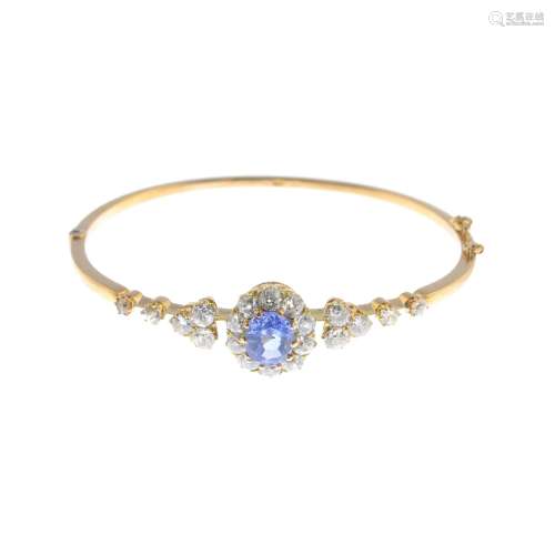 A sapphire and diamond hinged bangle.