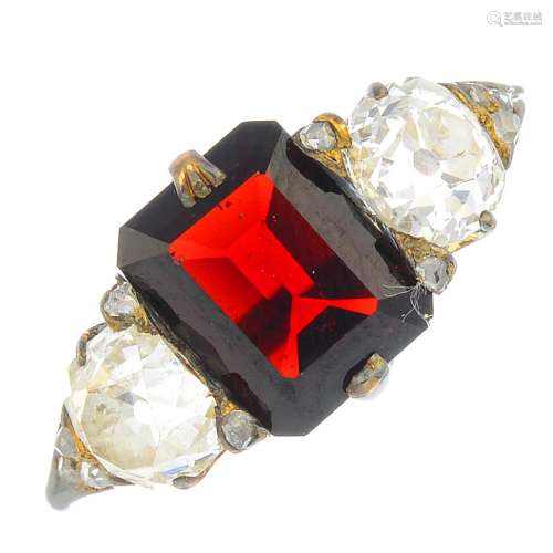 A late Victorian 18ct gold garnet and diamond three-stone ring.