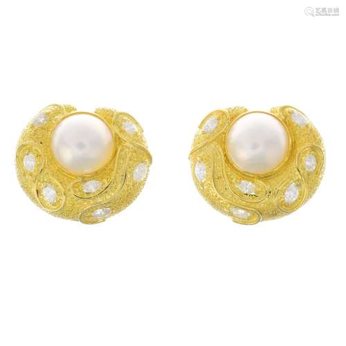 A pair of mabe pearl diamond earrings.