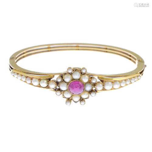 A late Victorian 18ct gold ruby and split pearl bangle.