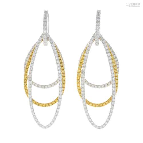 A pair of coloured diamond and diamond earrings.