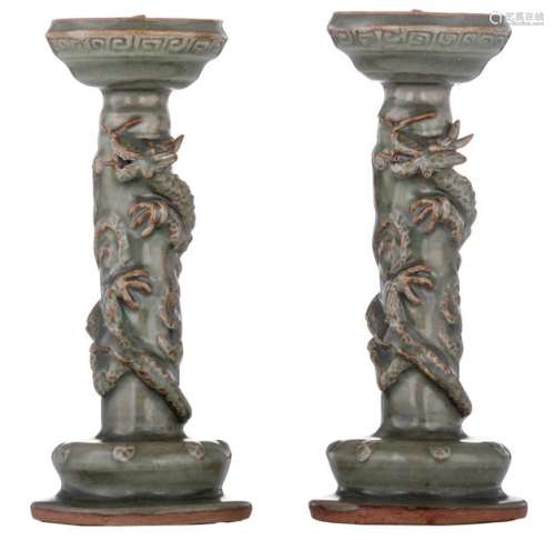 A pair of Chinese celadon stoneware candlesticks, ...;