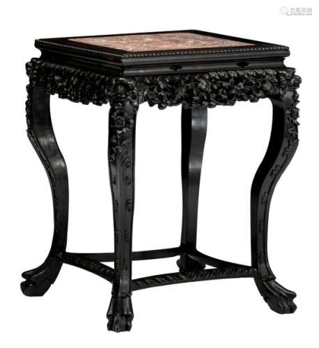 An occasional table in exotic hardwood, with a red...;