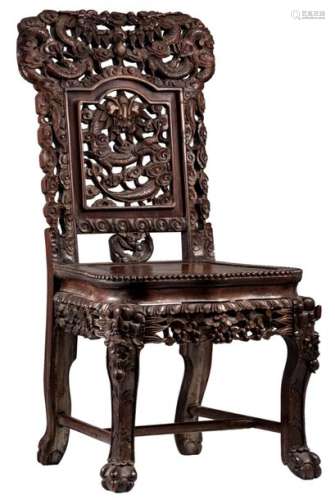 An Oriental richly carved hardwood chair with open...;