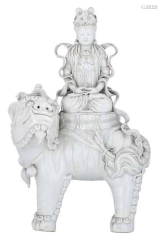 A large Blanc de Chine figure of a Guanyin on a Bu...;