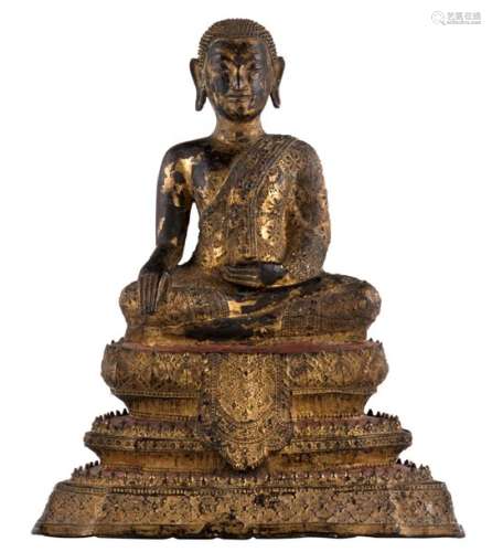 A Thai gilt bronze seated Buddha on a three level ...;