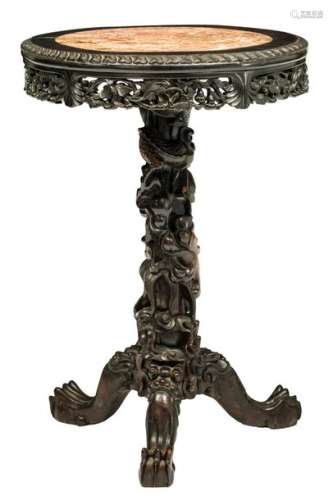 An Oriental hardwood tripod table, richly sculpted...;