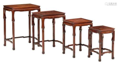 A set of four Oriental nesting tables, in exotic h...;