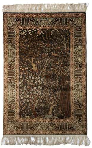 An Oriental silk carpet, decorated with a paradisi…
