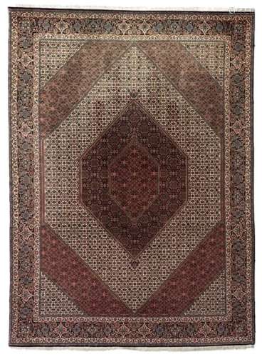 An Oriental woollen rug with floral motifs, 247 x …
