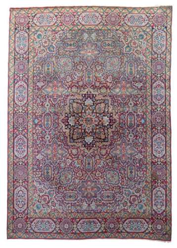 An Oriental woollen rug, decorated with floral mot…