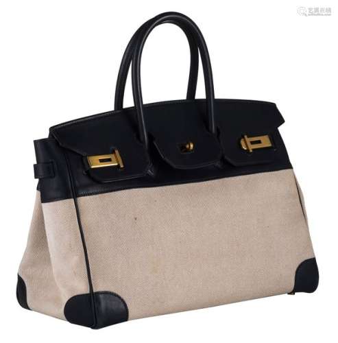 A Hermès Birkin bag in ebene leather and natural t…