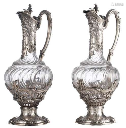 A pair of cut glass decanters with French silver r…
